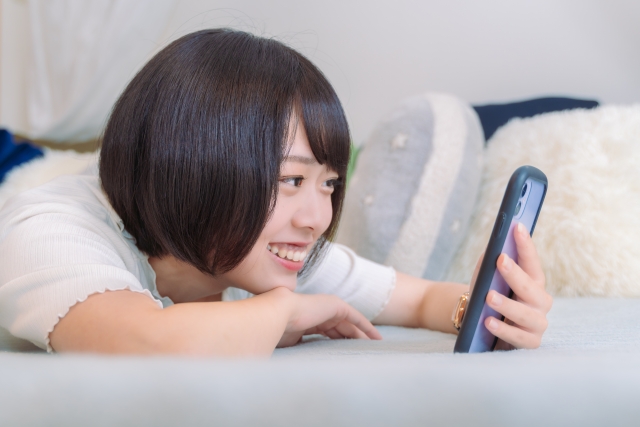 ゲームをする女性、スマホゲーム